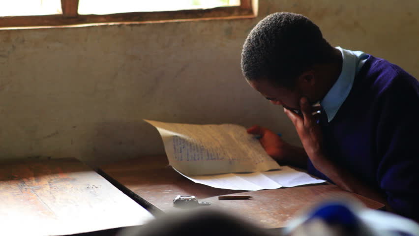 KENYA, AFRICA - AUGUST 2010: Students taking a test in class in a school in a
