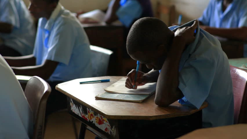 KENYA, AFRICA - AUGUST 2010: Students taking a test in class in a school in a