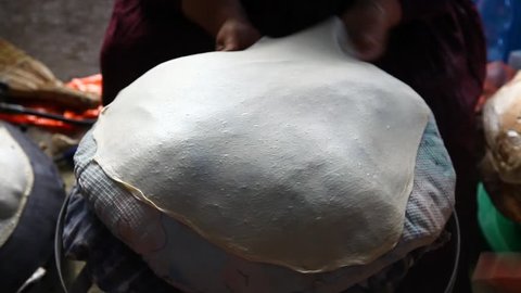 Baking Mediterranean Pita bread on hot plate