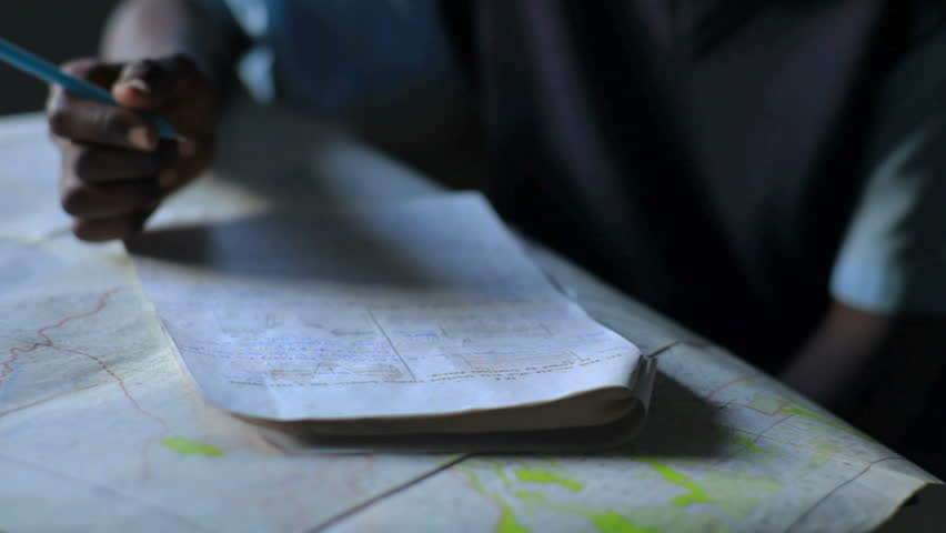 Students taking a test in class in a school in a village in Kenya two hours