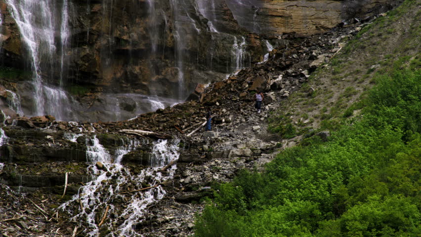 People on the rocky hillside at the bottom of Bridal Veil Falls in Provo Canyon,
