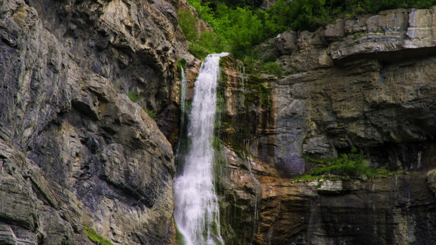 Tilt shot showing water falling down the full height of Bridal Veil Falls in