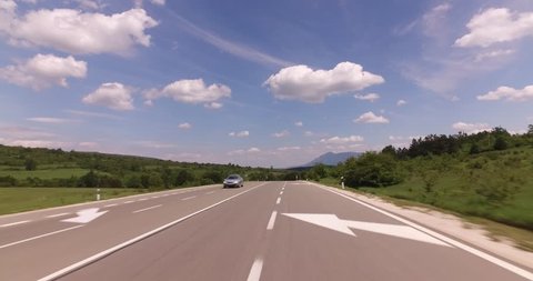 Driving car on Balkan route, hills, threes and curvy road