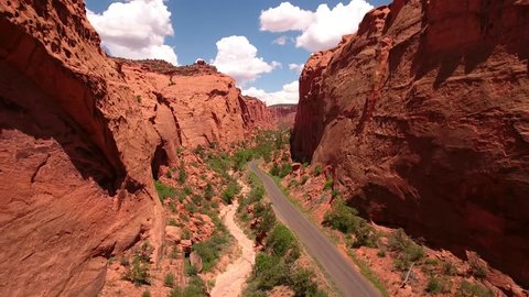 A beautiful aerial shot traveling up a beautiful red rock desert canyon on the Burr trail road in Utah