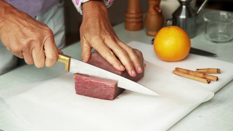 Barcelona, Spain - November 10, 2012: Woman slicing fresh tuna