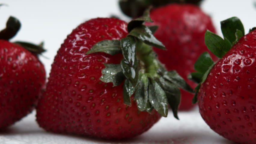 Close up slow pan across strawberries.