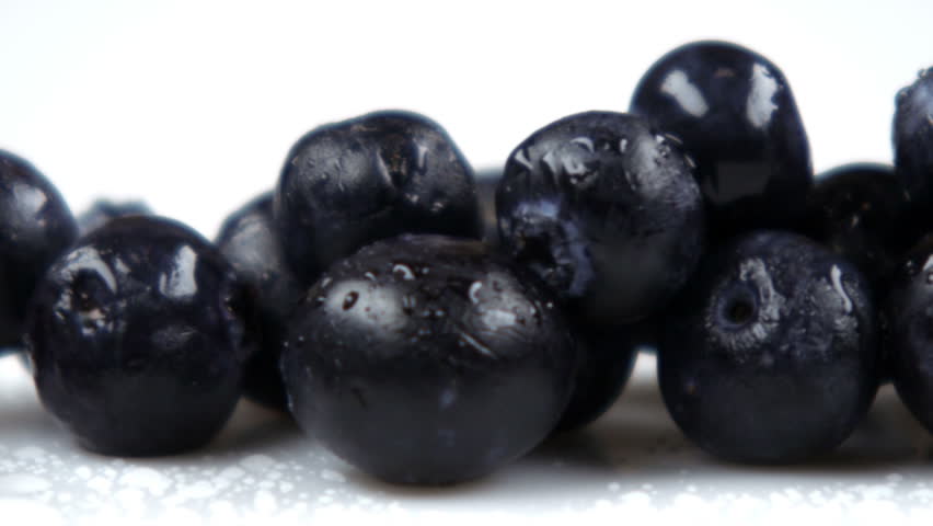 Close up slow pan across blueberries.