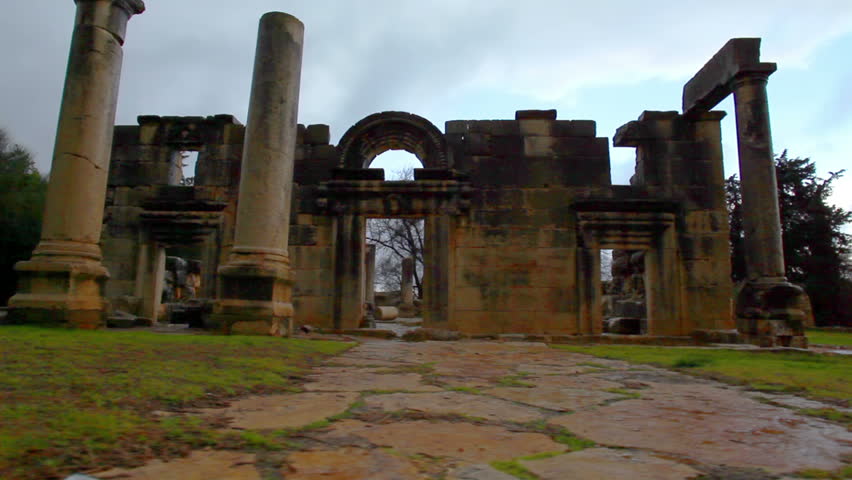 Wide dolly left to right of the entrance facade of the ruins of one of the