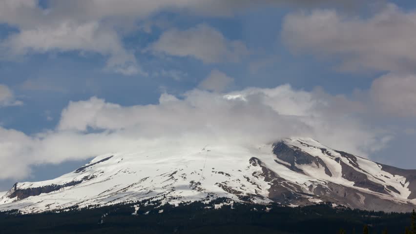 Ultra high definition 4k time lapse movie of moving clouds and fog over majestic Mount Hood in Oregon closeup 4096x2304
