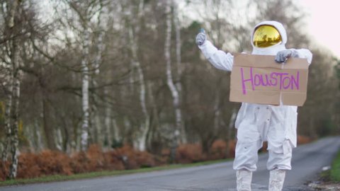 4K Astronaut returned to earth trying to hitch a ride from passing traffic. Shot on RED Epic. UK - April, 2016