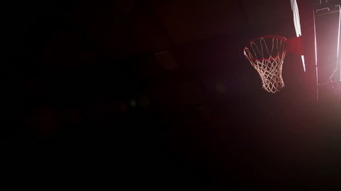 Two basketball players jump up and slam dunk, slow motion, view from below