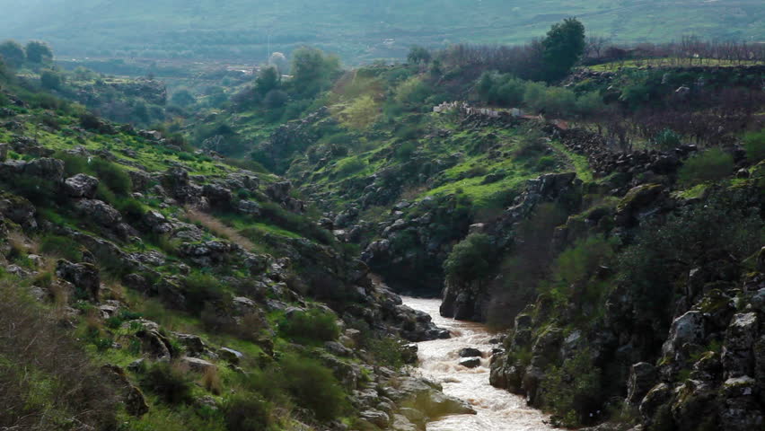 Wide shot of a winding river from the mountains of the Golan Heights in Israel. 