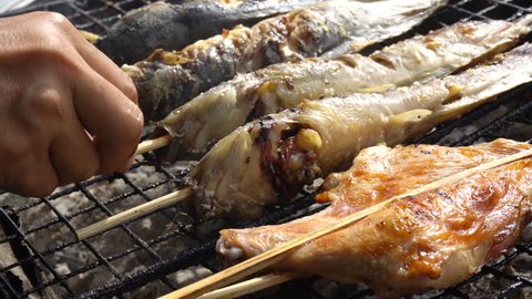 Grilled catfish on the stove, street market in THAILAND 
