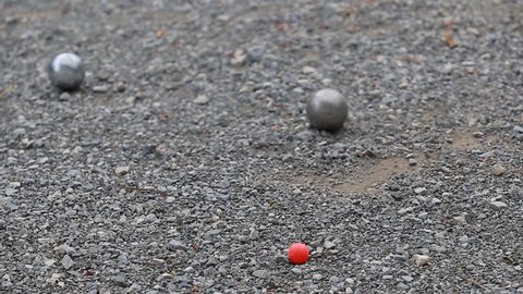 Video 1080p FullHD - Selective focus shifting from front to back of petanque game on a 
Field scree.