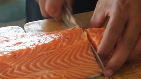 Cut salmon fish into pieces. 