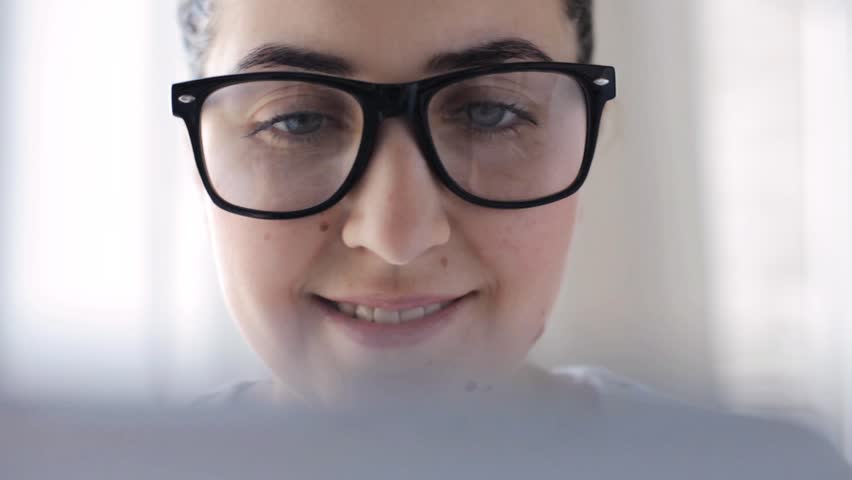 Education, business, people, technology and leisure concept - young woman in eyeglasses with tablet pc computer at home | Shutterstock HD Video #17040343