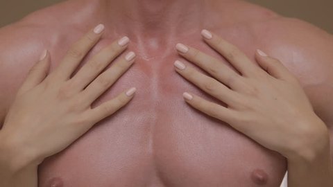 Hands of young woman touching athletic torso with abs of man. Ungraded