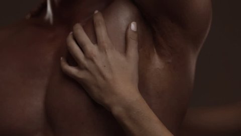 Hands of young woman touching athletic torso with abs of man. Graded