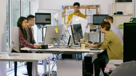4K Time lapse of young computer experts working in office with lots of computers. Shot on RED Epic. UK - April, 2016