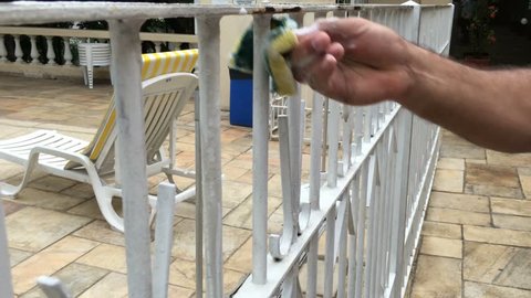 Close up of man hands cleaning metal gate