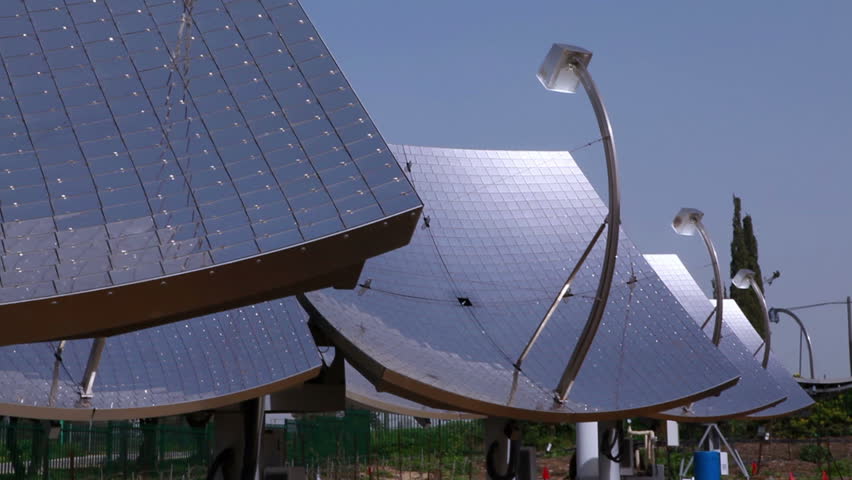Pan from right to left from three solar panels to just one panel filling the