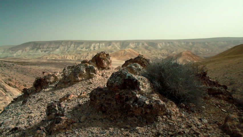 Dolly move along desert floor of the Mitzpe Ramon Crater in Israel.  Small,