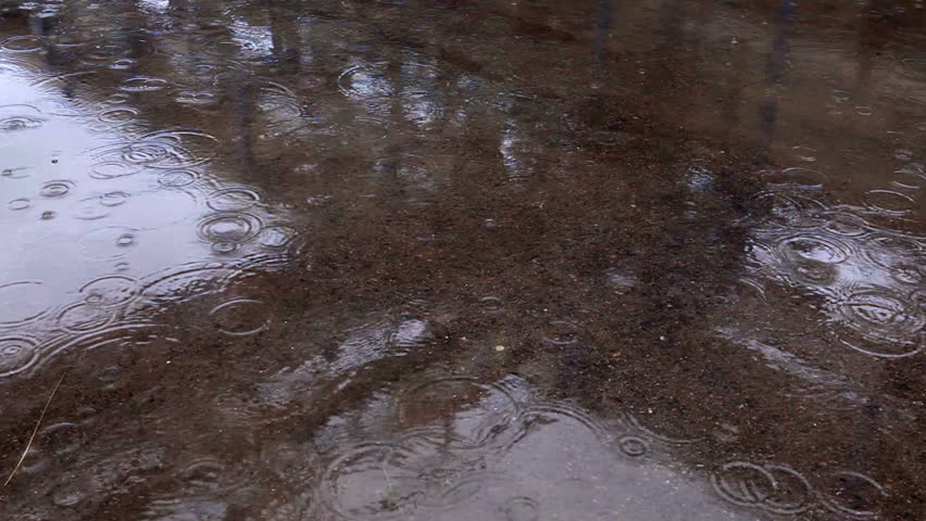 Rain drops splashing in the pools on a concrete walkway at the IDE Ashkelon