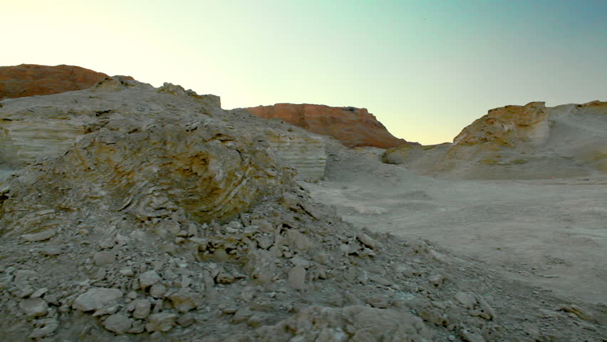 Dolly slider move left to right of rock formations in the desert of the Ein Gedi