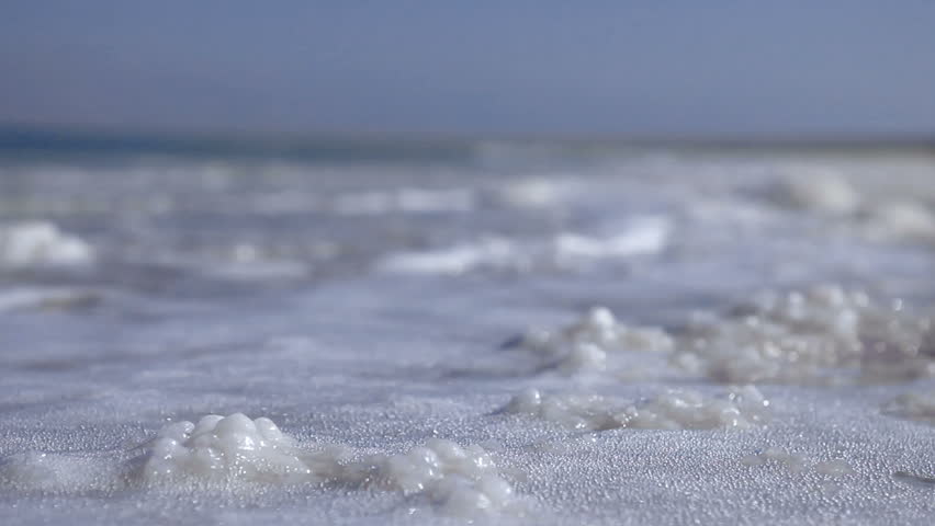 Low angle of the waves from the Dead Sea in Israel, lapping over the salt
