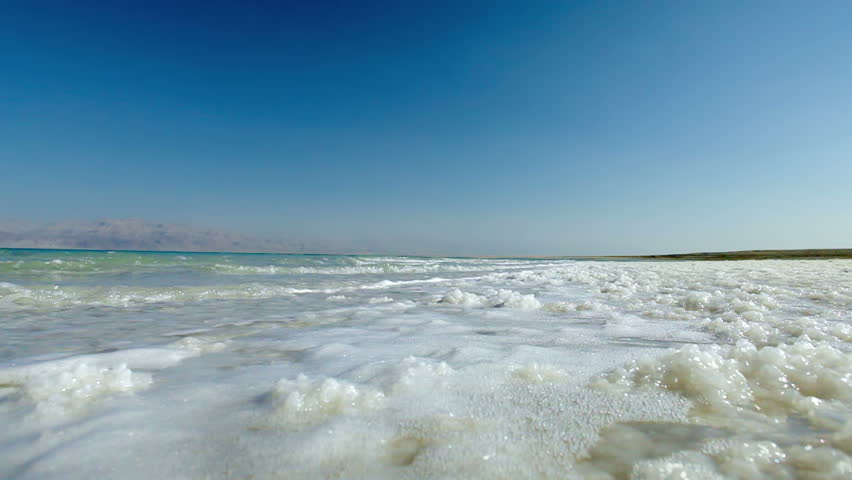 Beautiful low angle shot of the waves from the Dead Sea in Israel lapping over