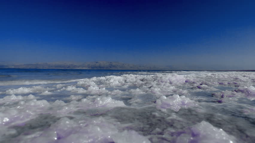 Beautiful low angle shot of the waves from the Dead Sea in Israel lapping over