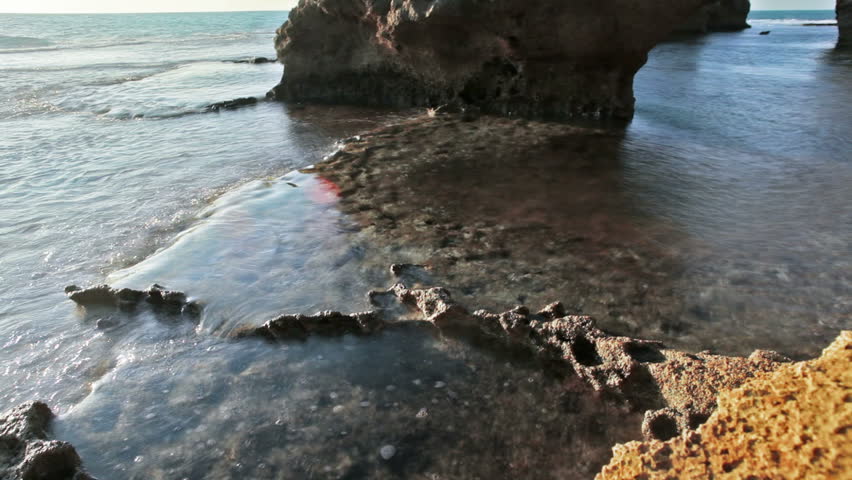 A tidal pool emptying back into the Mediterranean Sea in Israel at Dor Beach. 