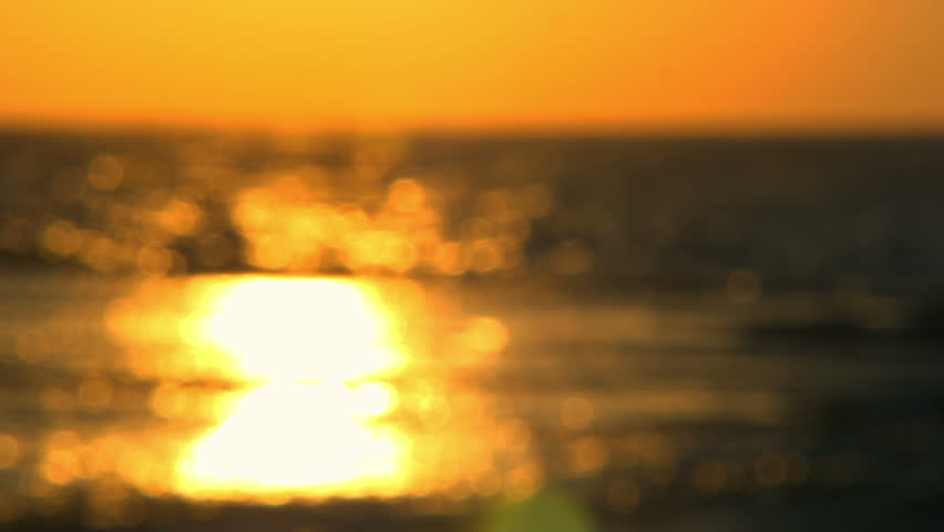 Racked focus of golden sunset over the Israeli Mediterranean at Dor Beach.  