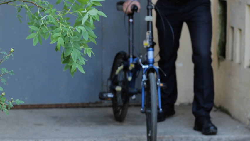 Businessman with bicycle touch smartphone