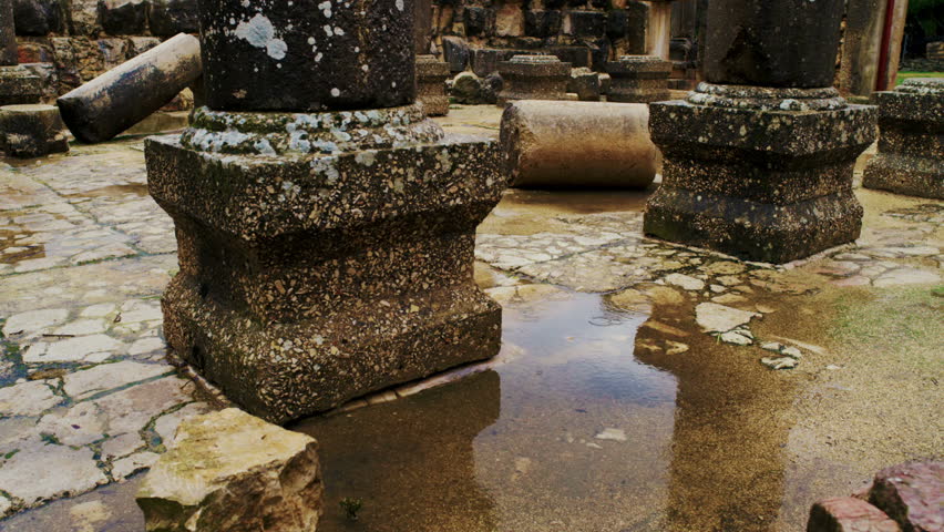 Static shot of water pooling at the base of the columns at the Bar'am synagogue
