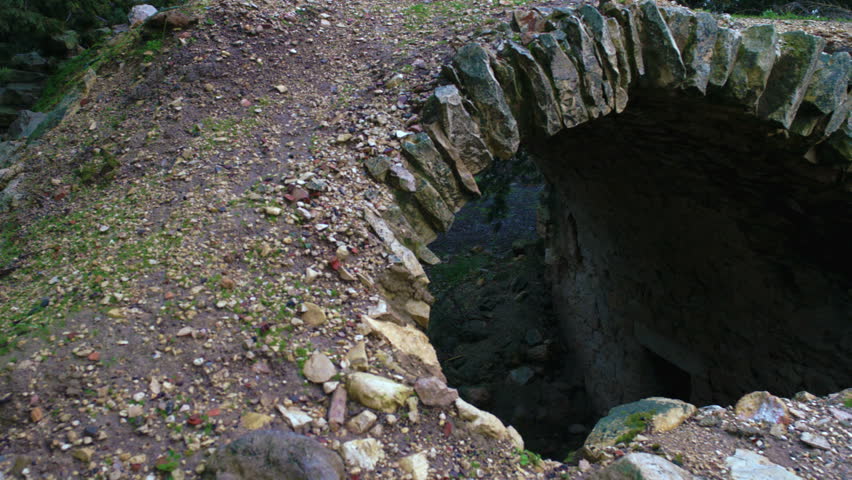 A pan left to right of an archway looking down to an under ground area with an