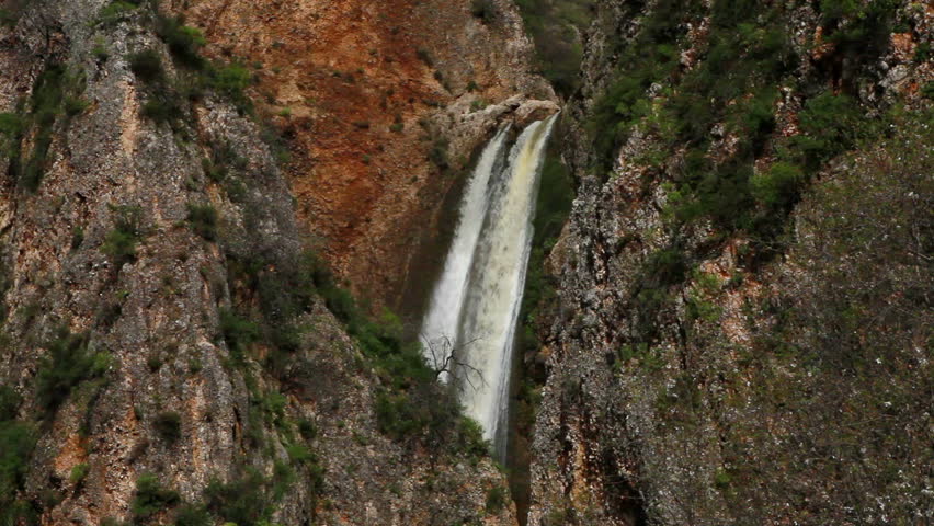 Medium wide shot of the top of the Iyon Tanur waterfall near Metula, Israel,