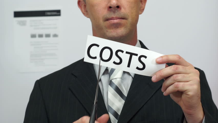 Male office worker or businessman in a suit and tie cuts a piece of paper with the word costs on it as a cost reduction business concept. Royalty-Free Stock Footage #17079334