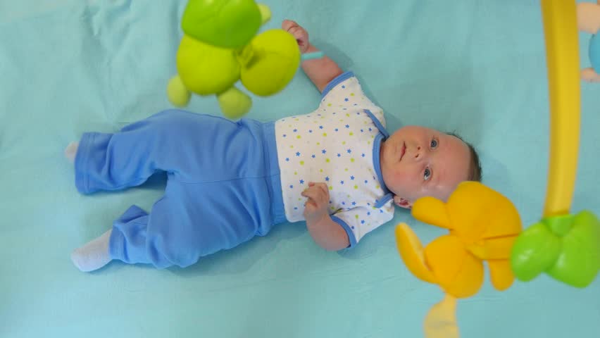 Newborn happy baby playing with children