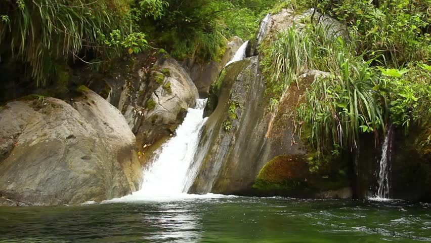 Small waterfall in Ecuadorian cloudforest, shot from the water level