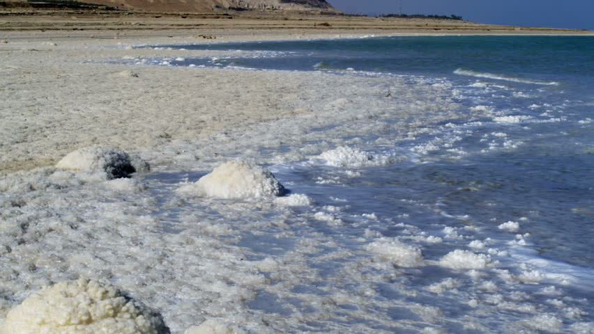 Salty shoreline of the Dead Sea in Israel,  Move left to right of waves coming