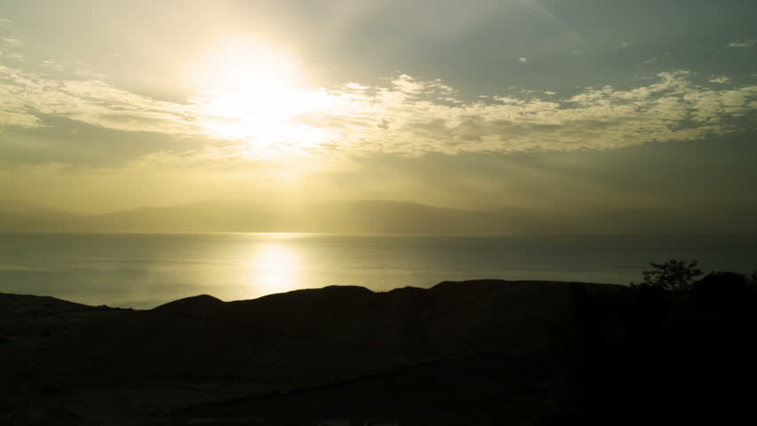 Silhouetted foreground rock, dawn at the Dead Sea in Israel looking east toward