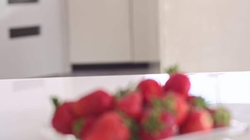 Young woman with strawberries, slow motion