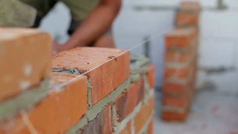 Work lays bricks on a construction site
