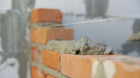 Work lays bricks on a construction site