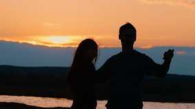 silhouettes of a couple at the lake makes selfie slow motion video