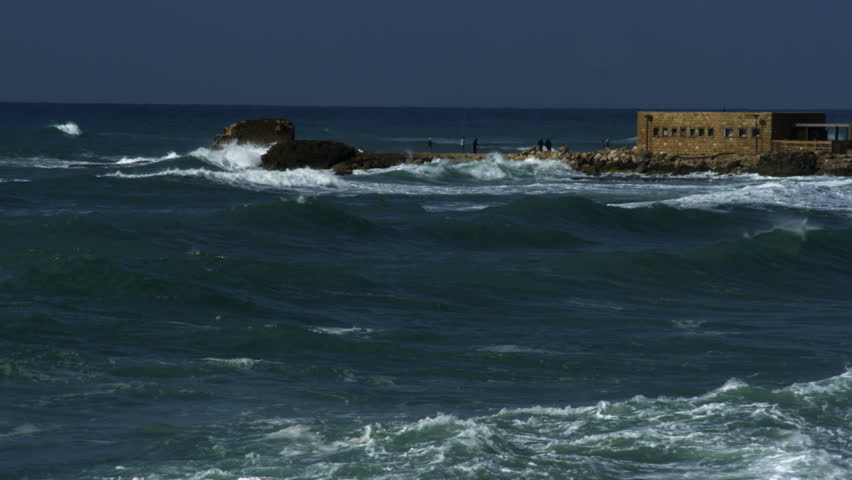 Pan from left to right following the Mediterranean waves off the coast of