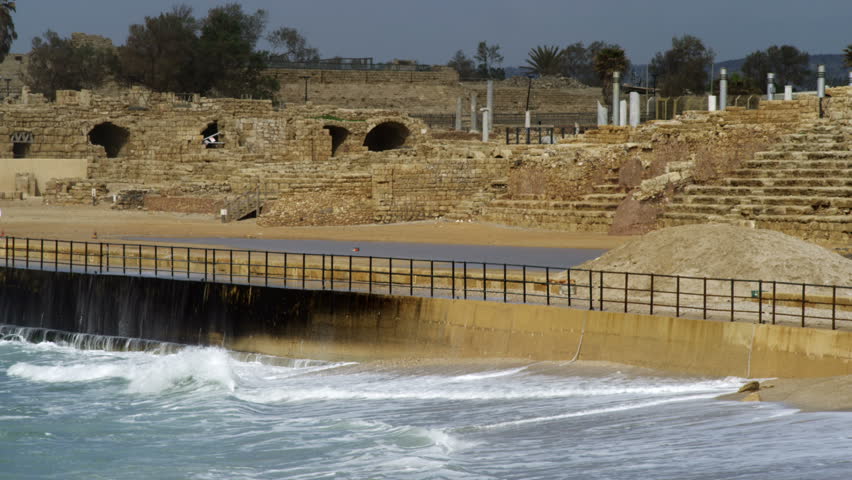 Mediterranean waves crashing into the retaining wall protecting some of the