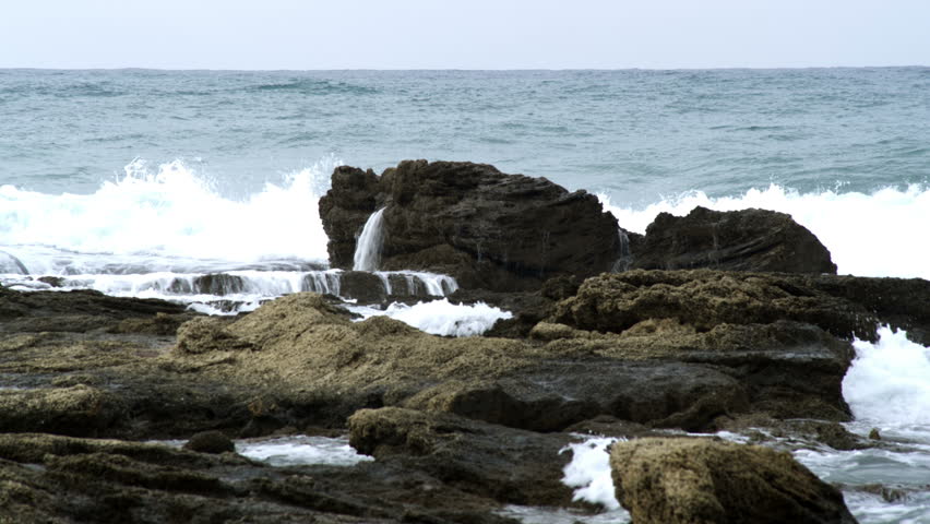 Waves rolling over outcrop of remaining partial ruin at Ceasarea Israel.