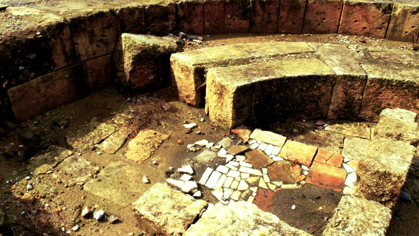 Pan, medium, shot of the different layers of the bathhouse area ruins at the